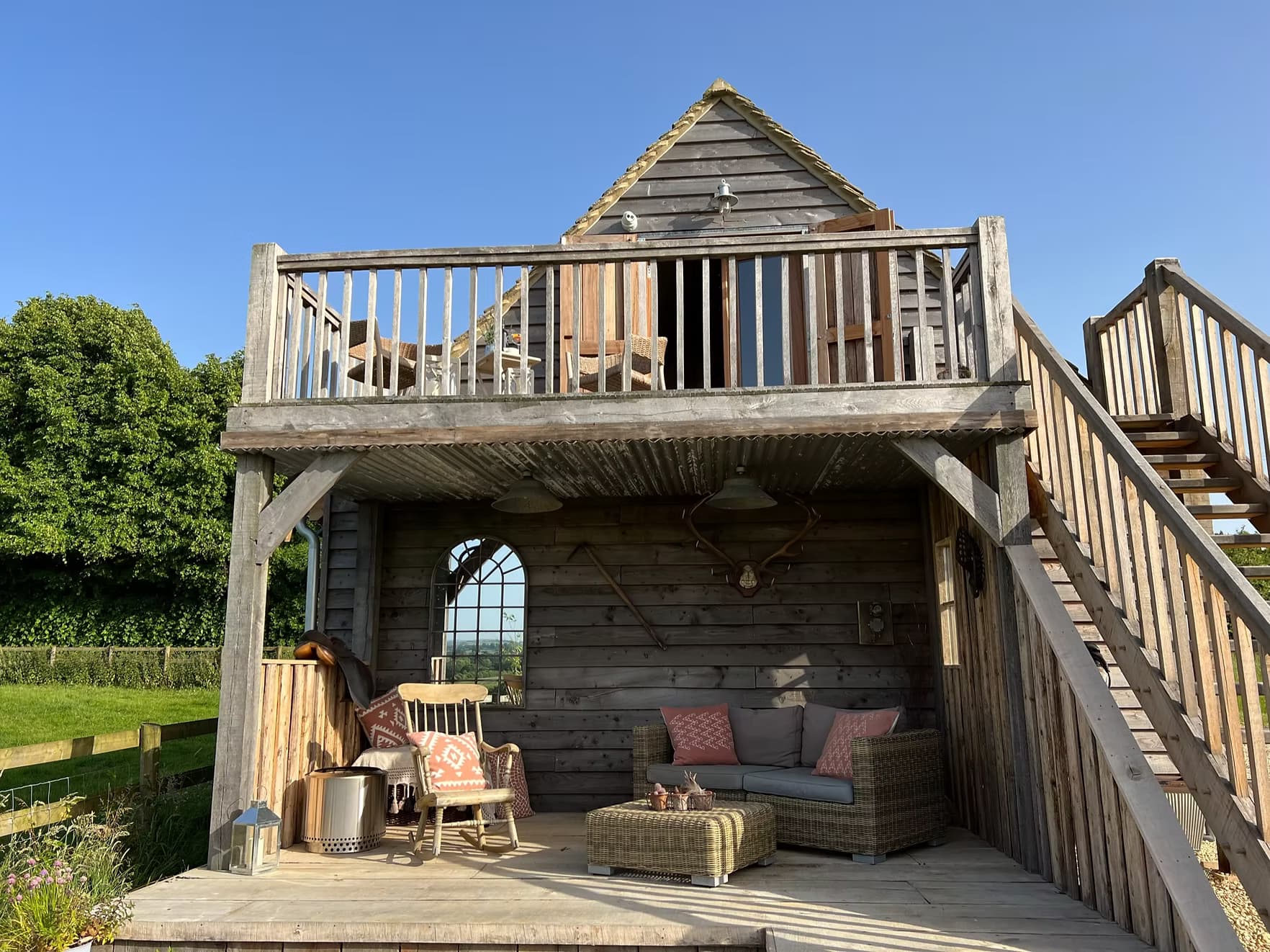 The Hayloft exterior at golden hour, surrounded by wildflower meadow